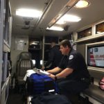 Firefighters Russell Korson and Keith O'Neil conducting an equipment check and inventory of the ambulance's EMS supplies. 